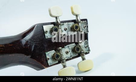 Ukulele head with 4 tuners and strings Stock Photo