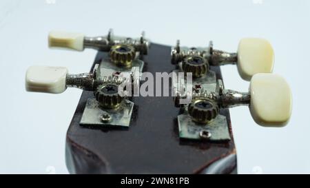 Ukulele head with 4 tuners and strings Stock Photo