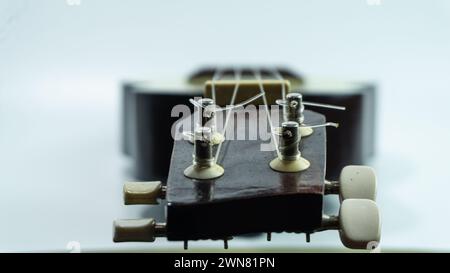 Ukulele head with 4 tuners and strings Stock Photo