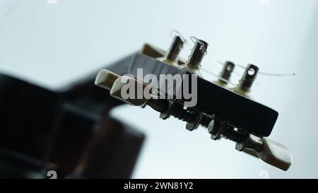 Ukulele head with 4 tuners and strings Stock Photo