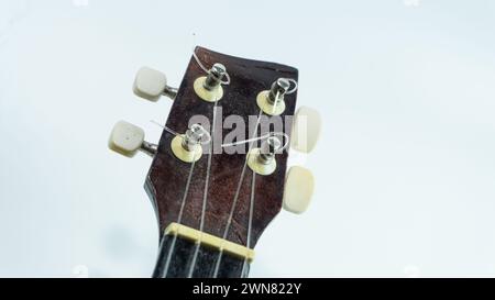 Ukulele head with 4 tuners and strings Stock Photo