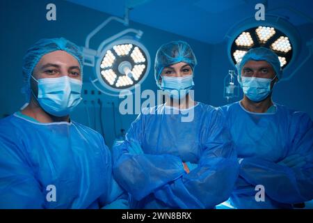 Professional surgeons in hospital operating theater wearing sterile uniforms Stock Photo