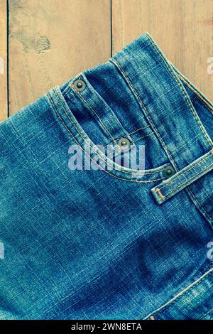 Close up of blue jeans ,Blue Jeans texture on wooden floor vintage filter Stock Photo