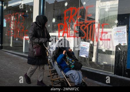 Glasgow, UK, 1st Mar 2024. Smashed windows and graffiti reading “Barcleys funds genocide” and “Free Palestine” on the Barclays Bank in Shawlands area of Glasgow, Scotland, on 1 March 2024. Photo by Jeremy Sutton-Hibbert/Alamy Live News. Stock Photo