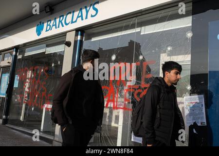 Glasgow, UK, 1st Mar 2024. Smashed windows and graffiti reading “Barcleys funds genocide” and “Free Palestine” on the Barclays Bank in Shawlands area of Glasgow, Scotland, on 1 March 2024. Photo by Jeremy Sutton-Hibbert/Alamy Live News. Stock Photo