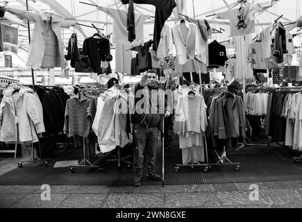 street vendor with his clothes stall, the photograph was taken in Parma on 11/25/2023 Stock Photo