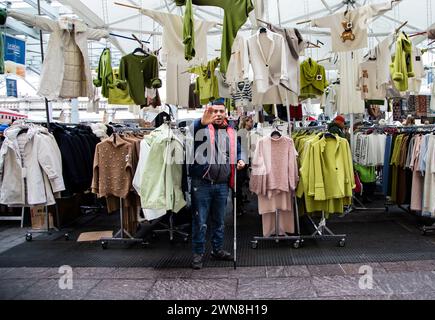 street vendor with his clothes stall, the photograph was taken in Parma on 11/25/2023 Stock Photo