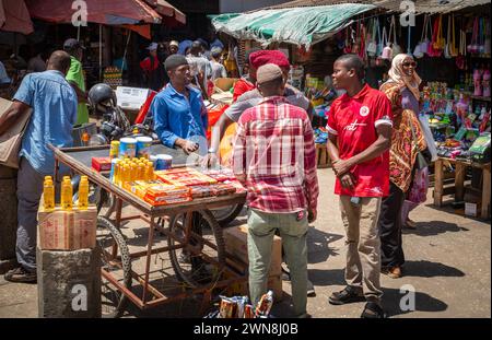 Men stand and chat in Stone Town Market in Zanzibar, Tanzania Stock Photo