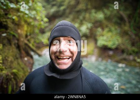 Portrait of man in wetsuit making a happy funny face Stock Photo