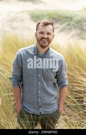 Portrait of middle aged man smiling while at the beach Stock Photo