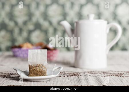 Tea bag ready for brewing on a plate Stock Photo