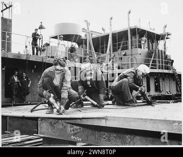 Vintage photographs of women welding parts of depth charge weapons in the Second World War, part of the important contribution of women to the war efforts.  Chippers in a Shipyard ,Shipbuilding, Three Women Working/  1942 Stock Photo