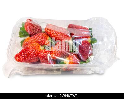 Red ripe strawberries in plastic tray and packed in clear plastic bag for sale. Isolated on white with clipping path included Stock Photo