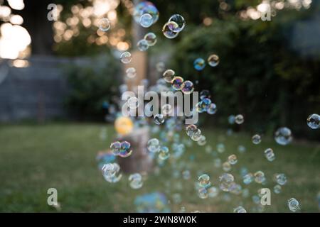 Bubbles Floating In The Air During Summertime Play Stock Photo