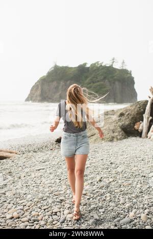 Portrait of young woman with long blonde hair flowing in wind on beach Stock Photo