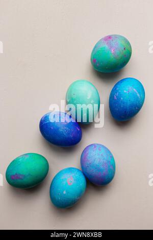 Blue and green dyed Easter eggs against pink backdrop Stock Photo