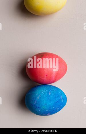 Three dyed Easter eggs  against a pink backdrop Stock Photo