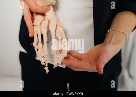 Doctor explaining operation to foot on bone model Stock Photo