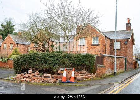 Damaged brick wall hit by vehicle in town centre of Crewe UK Stock Photo