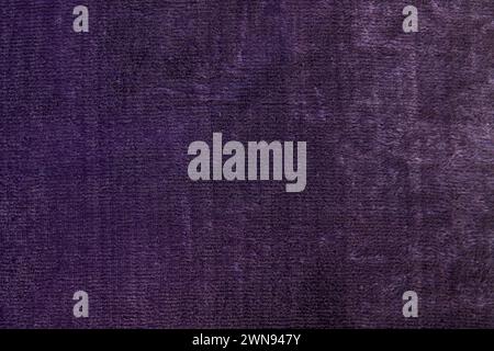 Texture of fabric. Dark purple old velvet fabric texture used as background. Violet background. Close up white cloth texture background. Top view. Stock Photo