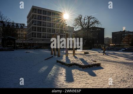 Sunbeams shining through a building in a city, in winter, people walking in the background, Deweerthscher Garten, Elberfeld, Wuppertal, Bergisches Stock Photo