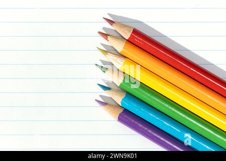 Pride flag created by a group of colored pencils on white lined paper. Copy space Stock Photo