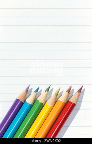 Pride flag created by a group of colored pencils on white lined paper. Copy space Stock Photo