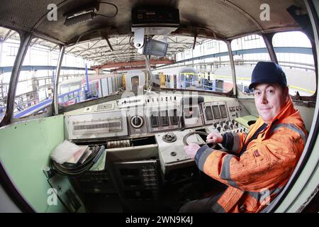 01 March 2024, Saxony-Anhalt, Halberstadt: Michael Brandes from VIS Halberstadt sits in the power car of the SVT. The GDR prestige train SVT is slowly placed on the chassis using a lifting platform. After this step, the further refurbishment of the SVT can continue. Under the watchful eyes of numerous guests, the engine car VT 18.16.10 was raised to approx. 2.60 meters by means of four lifting jacks in the railroad depot of VIS Halberstadt, then the bogies were positioned exactly under the vehicle. Finally, the vehicle is slowly lowered until it stands on its own wheels again. The train should Stock Photo