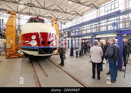 01 March 2024, Saxony-Anhalt, Halberstadt: The GDR prestige train SVT is slowly placed on the chassis using a lifting platform. After this step, the further refurbishment of the SVT can continue. Under the watchful eyes of numerous guests, the VT 18.16.10 engine car was raised to approx. 2.60 meters in the VIS Halberstadt railroad depot using four lifting jacks, then the bogies were positioned exactly under the vehicle. Finally, the vehicle is slowly lowered until it stands on its own wheels again. The train should be ready for operation again in the 3rd quarter of 2024. The first test runs wi Stock Photo