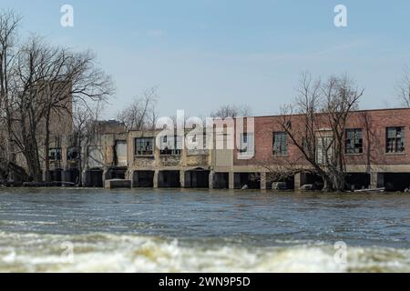 Old paper mill on the Fox River, Menasha WI USA. A lot of water is needed to manufacture paper. Stock Photo