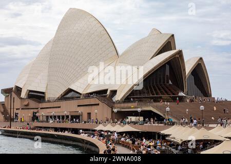 Sydney Opera House building, 2024, at bennelong point in Sydney with people enjoying lunch at Sydney opera house bar and restaurant, iconic Stock Photo