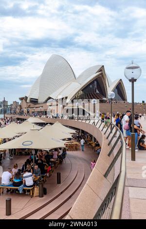 Sydney Opera House building, 2024, at bennelong point in Sydney with people enjoying lunch at Sydney opera house bar and restaurant, iconic Stock Photo