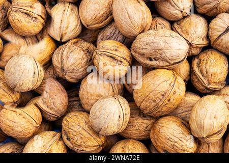 Natural walnut background pattern texture Abstract walnuts heap pattern background Blurred edges frame Natural food in-shell nuts walnuts pattern back Stock Photo