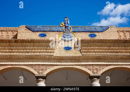 Main symbol of Zoroastrianism - the Faravahar, aka the Foruhar, or the Farre Kiyani, depicted on the facade of Zoroastrian Fire Temple in Yazd, Iran. Stock Photo