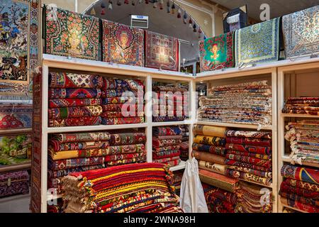 Colorful selection of handmade Persian carpets in Fazeli Carpet Shop. Yazd, Iran. Stock Photo