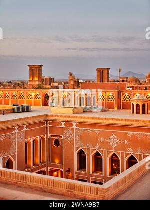Rooftop view of the old adobe houses illuminated at dusk in the historical Fahadan Neighborhood of Yazd, Iran. Stock Photo