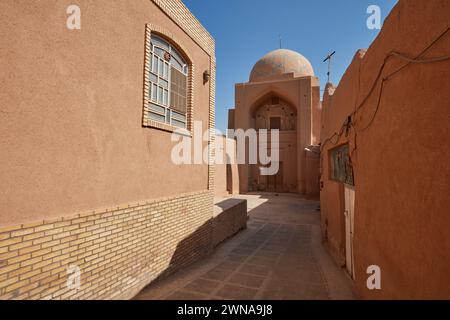 Traditional adobe buildings on a narrow street in the historical Fahadan Neighborhood of Yazd, Iran. Stock Photo