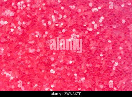 Red and Pink Glitter Pile Background Texture Close Up. Stock Photo