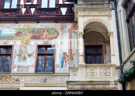 Sinaia, Romania - October 14, 2023: Yard of beautiful Peles castle with painted facade walls and wooden elements Stock Photo