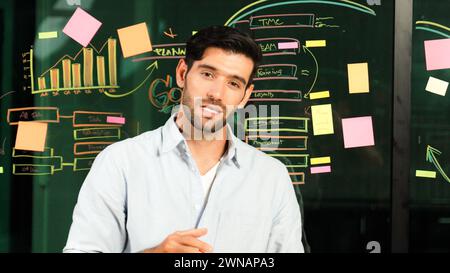 Professional manager explaining business plan to expert investors. Smart businessman sharing, presenting marketing strategy. Leader pointing at mind Stock Photo