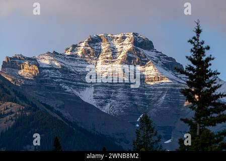 Sunset sky over Mount Rundle in Banff National Park during summer time with long daylight hours, blue, purple and pink tones above in wilderness area. Stock Photo