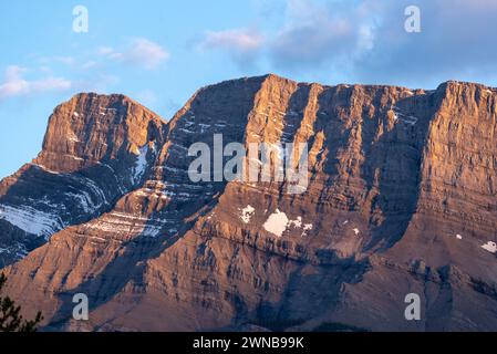 Sunset sky over Mount Rundle in Banff National Park during summer time with long daylight hours, blue, purple and pink tones above in wilderness area. Stock Photo