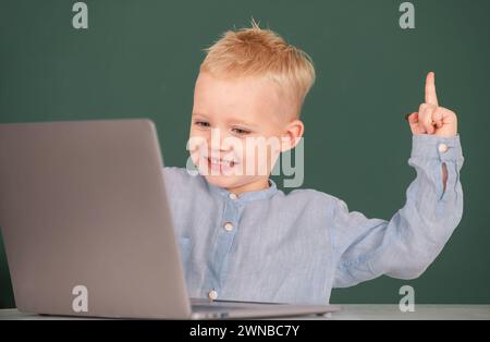 Amazed child using gadgets to study. Computer education for kids. Genius child programming, computer training. Stock Photo