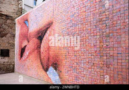 One of the most photographed murals in Barcelona is The Kiss of Freedom also known as The World Begins with Every Kiss. Stock Photo