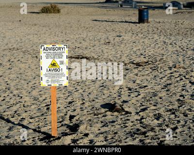 Sign warning beach goers, visitors, surfers of high bacteria levels in the water; Ocean Beach, San Diego, California; beach health advisory warning. Stock Photo
