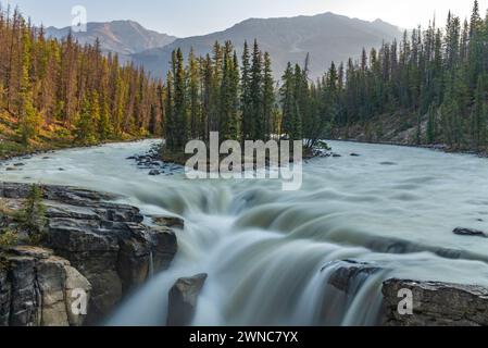 Sunwapta Falls in the stunning Canadian Rockies at sunrise in summertime with beautiful cascading waterfall in popular tourist, landscape area Canada. Stock Photo