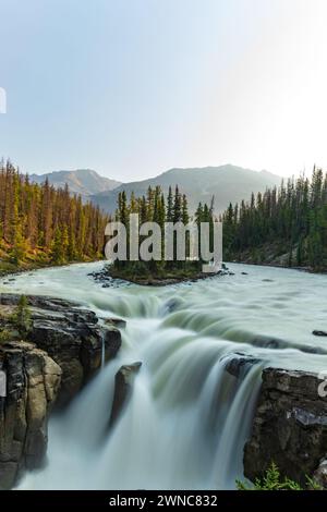 Sunwapta Falls in the stunning Canadian Rockies at sunrise in summertime with beautiful cascading waterfall in popular tourist, landscape area Canada. Stock Photo