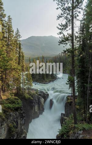 Sunwapta Falls in the stunning Canadian Rockies at sunrise in summertime with beautiful cascading waterfall in popular tourist, landscape area Canada. Stock Photo