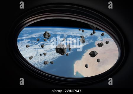 Spacecraft, Earth and asteroids. Asteroids fly over the Earth, as seen from the window of a spaceship. Elements of this image furnished by NASA. Stock Photo