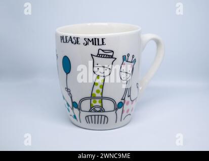 glass of tea with the motif of very happy girajas, holding a car on a white background Stock Photo